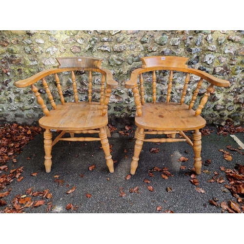 1105 - A pair of beech and elm smokers bow chairs. 