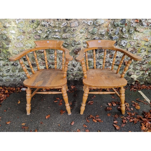 1106 - A pair of beech and elm smokers bow chairs.Ensuite with the previous lot.