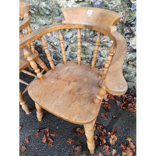 1106 - A pair of beech and elm smokers bow chairs.Ensuite with the previous lot.