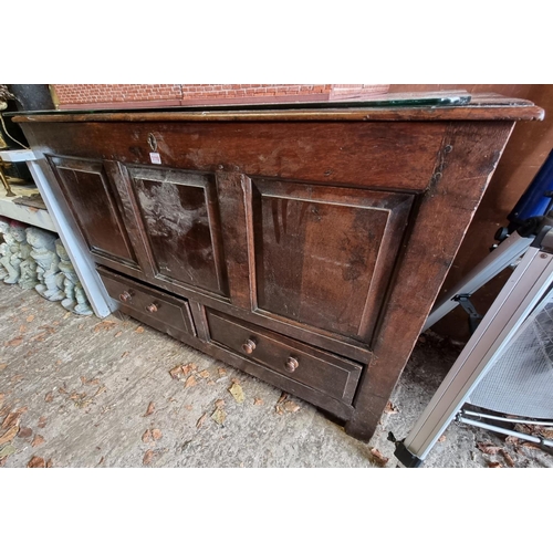 1110 - An early 18th century oak panelled mule chest, 31cm wide.