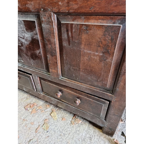 1110 - An early 18th century oak panelled mule chest, 31cm wide.