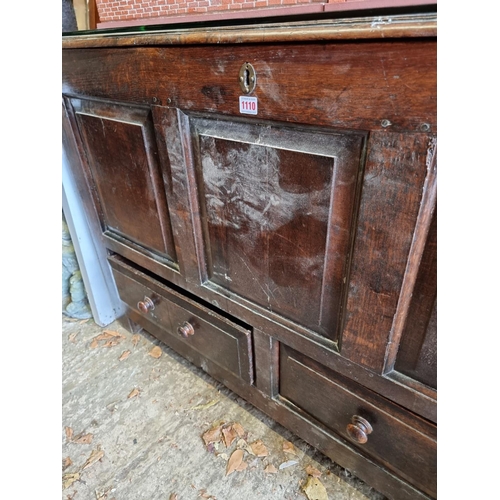 1110 - An early 18th century oak panelled mule chest, 31cm wide.