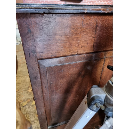 1110 - An early 18th century oak panelled mule chest, 31cm wide.