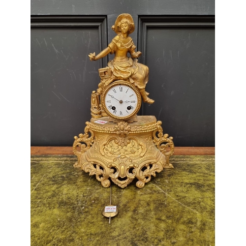 1180 - A gilt spelter mantel clock, 40cm high, with pendulum. 