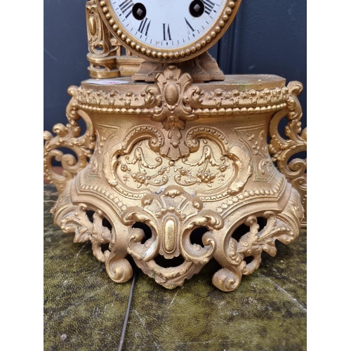 1180 - A gilt spelter mantel clock, 40cm high, with pendulum. 