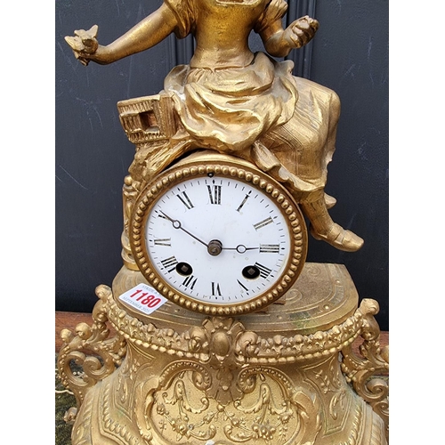 1180 - A gilt spelter mantel clock, 40cm high, with pendulum. 