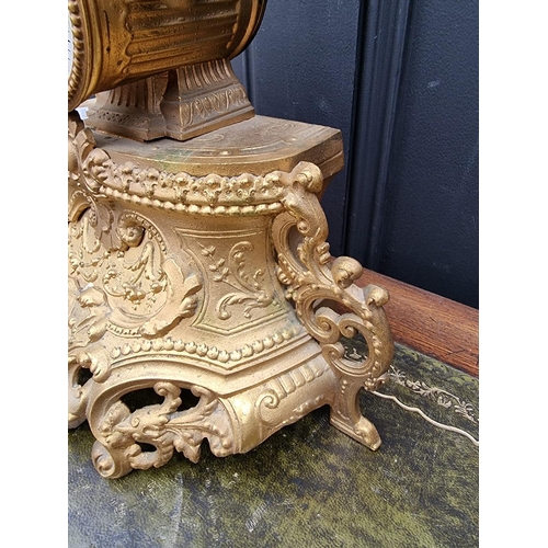 1180 - A gilt spelter mantel clock, 40cm high, with pendulum. 