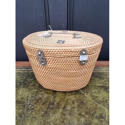 1187 - A Chinese famille rose teapot, cover and two tea bowls, in wicker case.