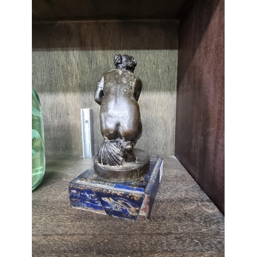 1375 - After the Antique, a bronze 'Crouching Venus', on blue marble base, 17cm high.