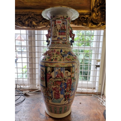 1454 - A large Chinese famille rose twin handled vase, 19th century, 62.5cm high, (cracks). ... 