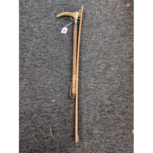 1545 - Two old swagger sticks, together with an antler and silver mounted riding crop.