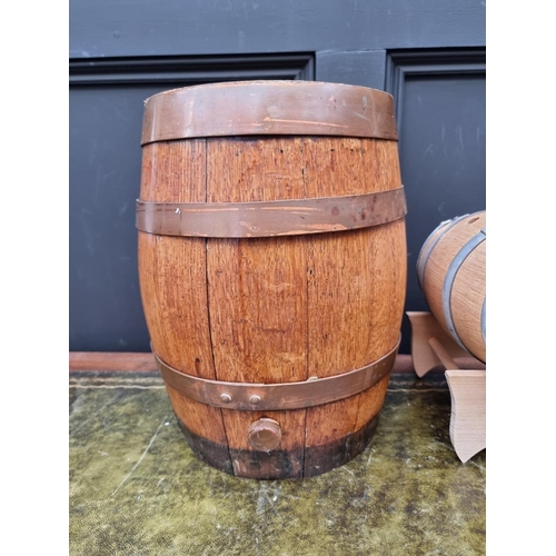 1553 - A small oak and copper coopered barrel, 34cm wide; together with a smaller coopered barrel on stand.... 