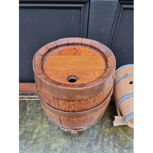 1553 - A small oak and copper coopered barrel, 34cm wide; together with a smaller coopered barrel on stand.... 