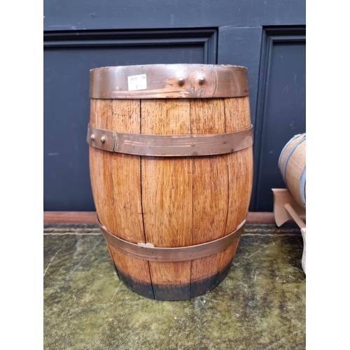 1553 - A small oak and copper coopered barrel, 34cm wide; together with a smaller coopered barrel on stand.... 