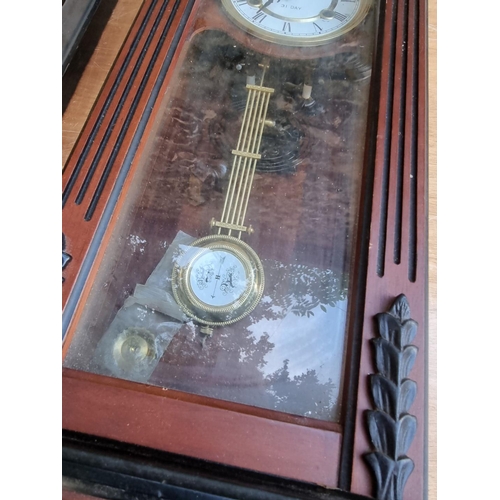 1560 - A 19th century ebonized Vienna style wall clock, 104cm high, with weight and pendulum; together with... 