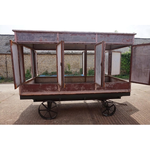 1548A - An early 20th century aluminium circus wagon, on four wheel base, 300cm long x 137.5cm wide x 2... 