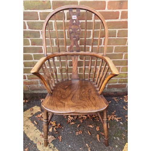 1082 - An old ash, elm and beech wheelback Windsor armchair. 