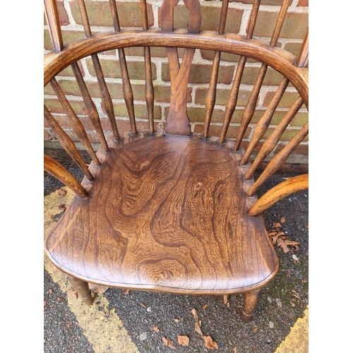 1082 - An old ash, elm and beech wheelback Windsor armchair. 