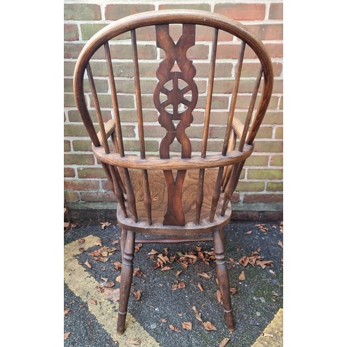 1082 - An old ash, elm and beech wheelback Windsor armchair. 