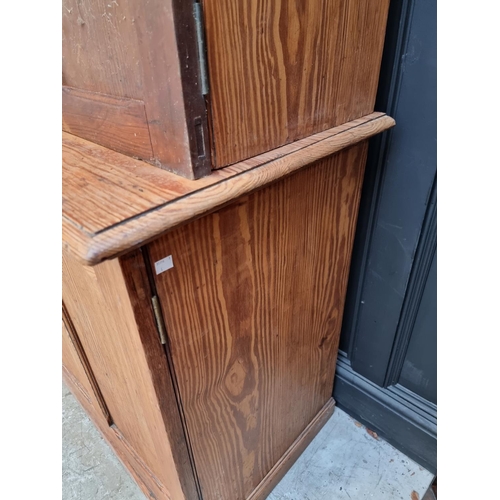 1001 - A Victorian pitch pine cabinet, with panelled doors, 216cm high x 183cm wide.  ... 