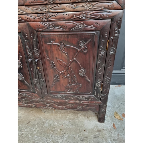 1002 - A Chinese carved hardwood display cabinet, late Qing, 195cm high x 90.5cm wide.