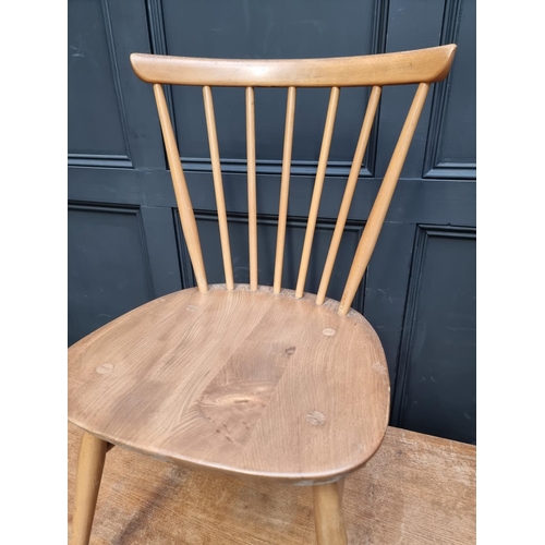 1007 - A vintage Ercol drop leaf table and three matching dining chairs, the table 125cm wide when open, (s... 