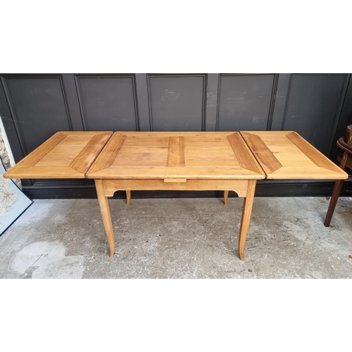 1008 - An old Continental pine drawleaf table, 109cm wide when closed.