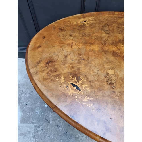 1023 - A Victorian burr walnut and inlaid oval breakfast table, 134cm wide.