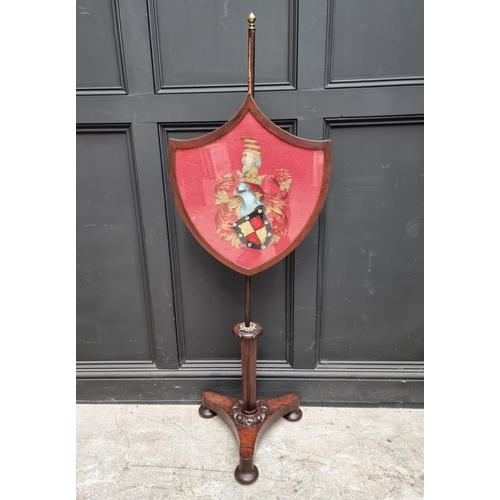 1027 - A George IV rosewood polescreen, the shield incorporating a watercolour painted crest.... 