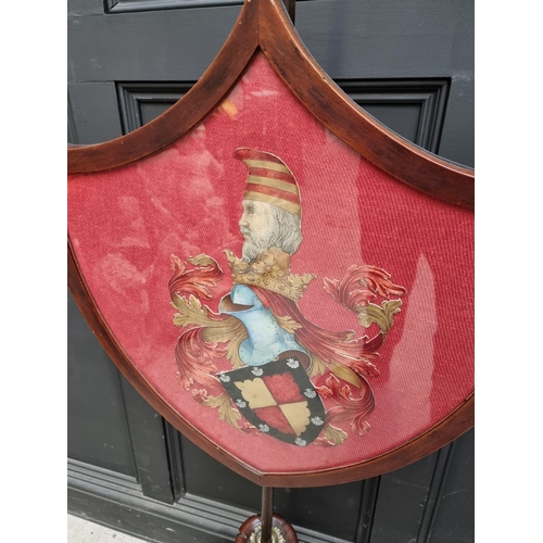 1027 - A George IV rosewood polescreen, the shield incorporating a watercolour painted crest.... 