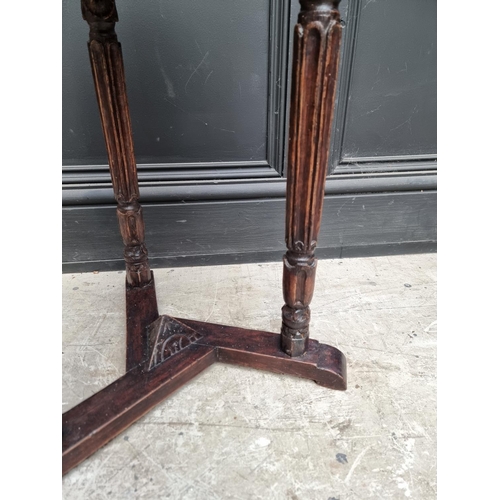 1028 - A Gothic style oak trefoil table, 39cm wide.