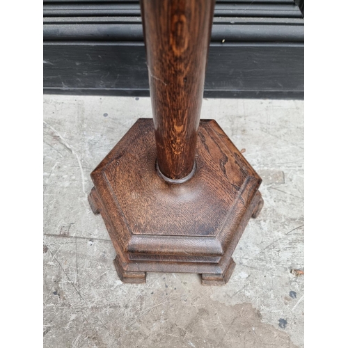 1030 - An oak torchere, with hexagonal base, 98cm high. 