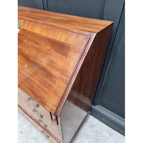 1034 - A George III mahogany and crossbanded bureau, 90.5cm wide.