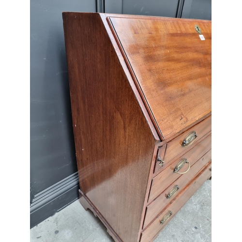 1034 - A George III mahogany and crossbanded bureau, 90.5cm wide.