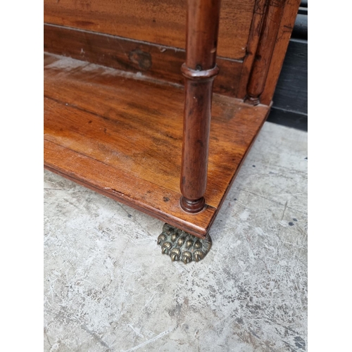 1037 - A Victorian mahogany open bookcase, 89cm wide, on brass paw feet.