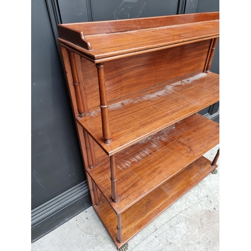 1037 - A Victorian mahogany open bookcase, 89cm wide, on brass paw feet.