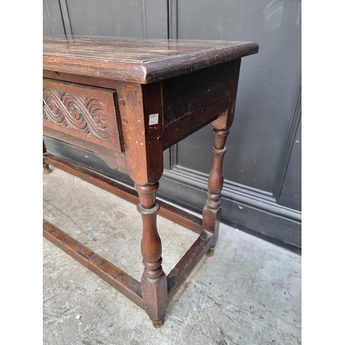 1046 - An antique oak two drawer side table, 125cm wide.