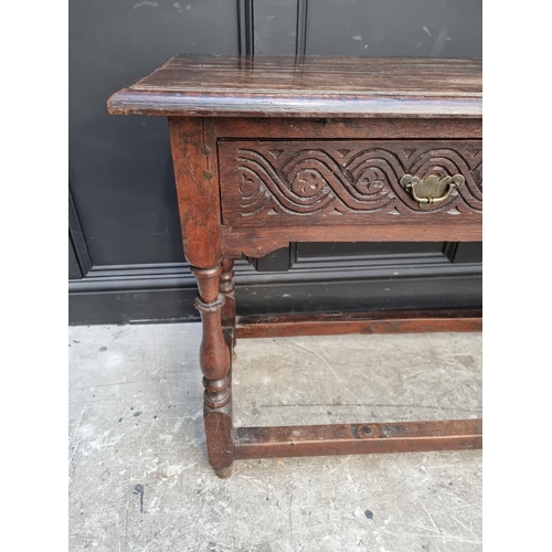 1046 - An antique oak two drawer side table, 125cm wide.