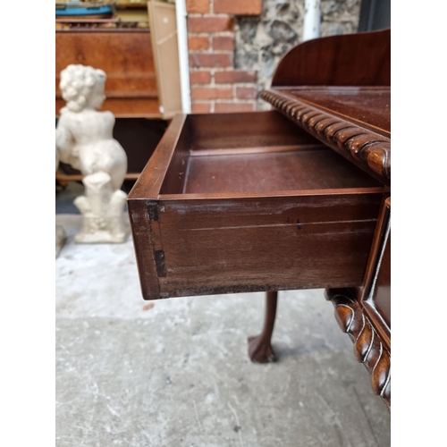 1057 - Au unusual reproduction carved mahogany desk, 103.5cm wide. 