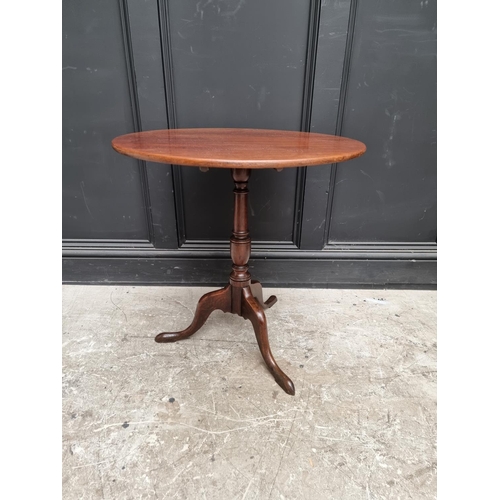 1071 - A George III mahogany circular tilt-top tripod table, with one-piece top, 63.5cm diameter.... 