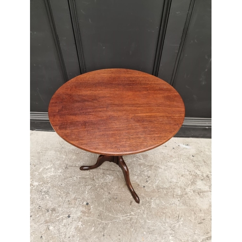 1071 - A George III mahogany circular tilt-top tripod table, with one-piece top, 63.5cm diameter.... 