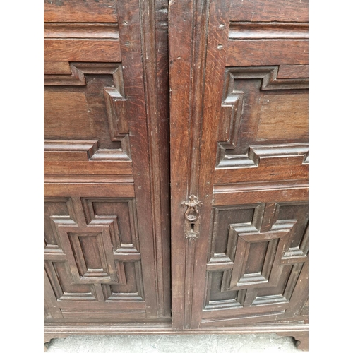 1073 - An unusual 17th century and later oak panelled cabinet, enclosing an arrangement of nine drawers, 11... 