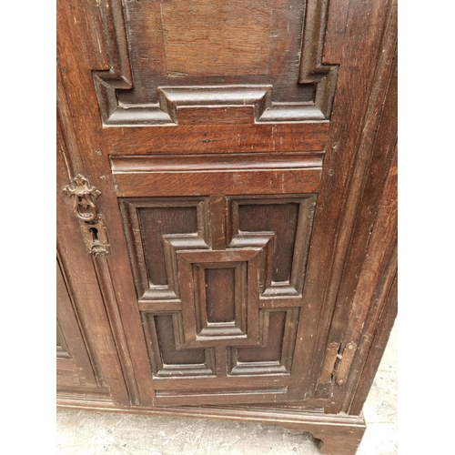 1073 - An unusual 17th century and later oak panelled cabinet, enclosing an arrangement of nine drawers, 11... 