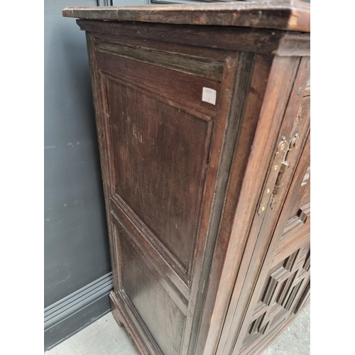 1073 - An unusual 17th century and later oak panelled cabinet, enclosing an arrangement of nine drawers, 11... 