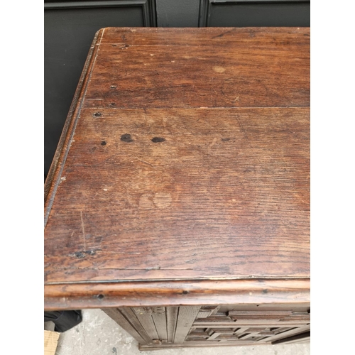 1073 - An unusual 17th century and later oak panelled cabinet, enclosing an arrangement of nine drawers, 11... 