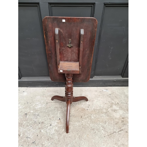 1075 - A Victorian mahogany rectangular tilt-top tripod table, 68cm wide.