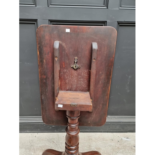 1075 - A Victorian mahogany rectangular tilt-top tripod table, 68cm wide.