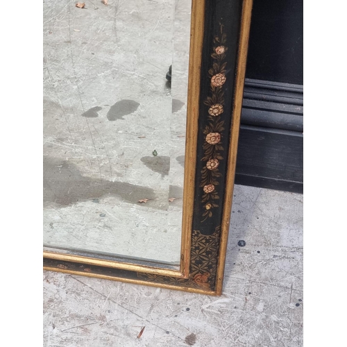 1074 - An 18th century style ebonized and parcel gilt framed wall mirror, 132cm high x 65cm wide. ... 