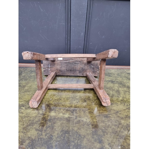 1015 - A small antique rustic pine milking stool, 33cm wide.