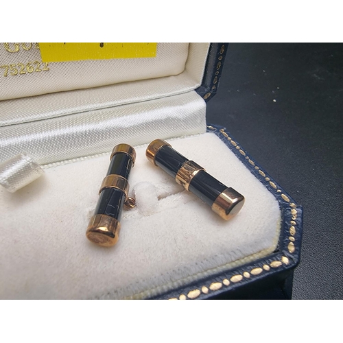 464 - A cased pair of 9ct gold and onyx cylinder cufflinks, by W H M, Birmingham 1999, 21mm long.... 